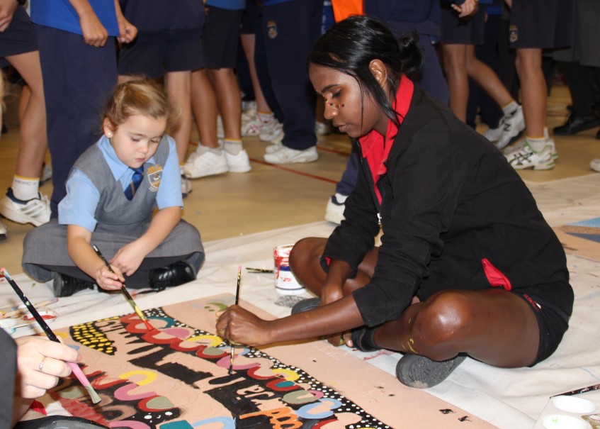 Tasimah Francis (right) from Clontarf College with Year Two student Amarah Dougan (left) from Mercy College Koondoola work together on an activity as part of NAIDOC Week celebrations at Mercy College.